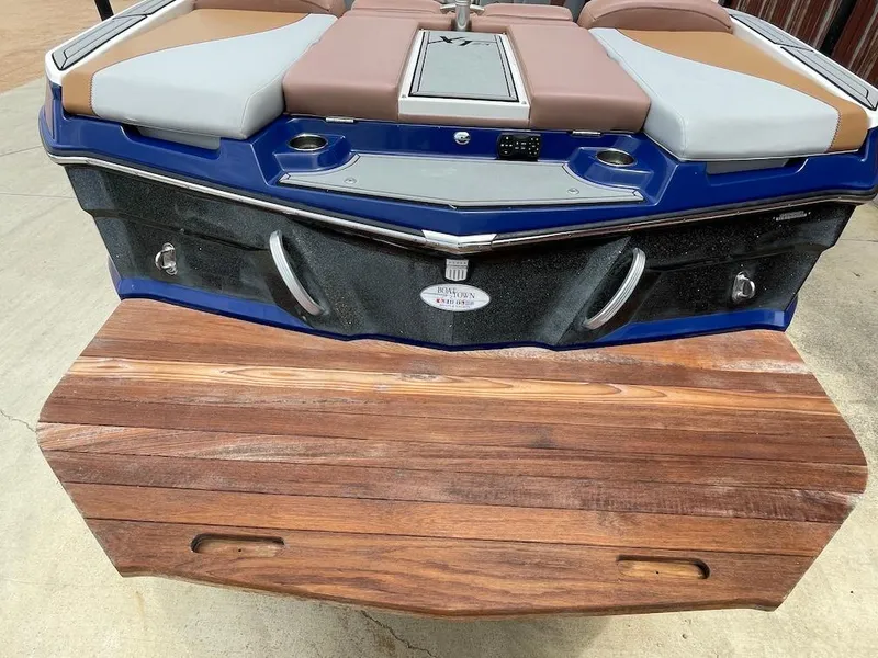 Slide: The Image of 2019 MasterCraft XT23 boat rear view with wooden swim platform. - 4