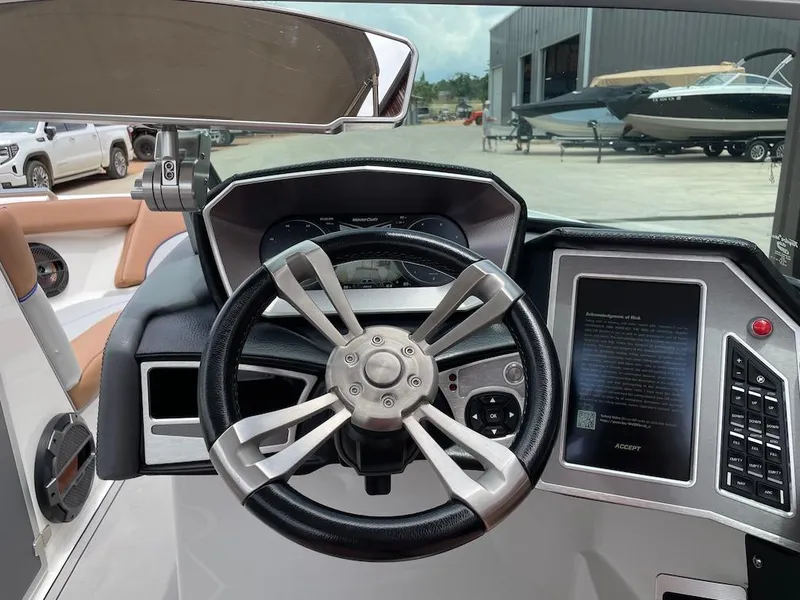 Slide: The Image of 2019 MasterCraft XT23 boat dashboard with steering wheel and control panel. - 9