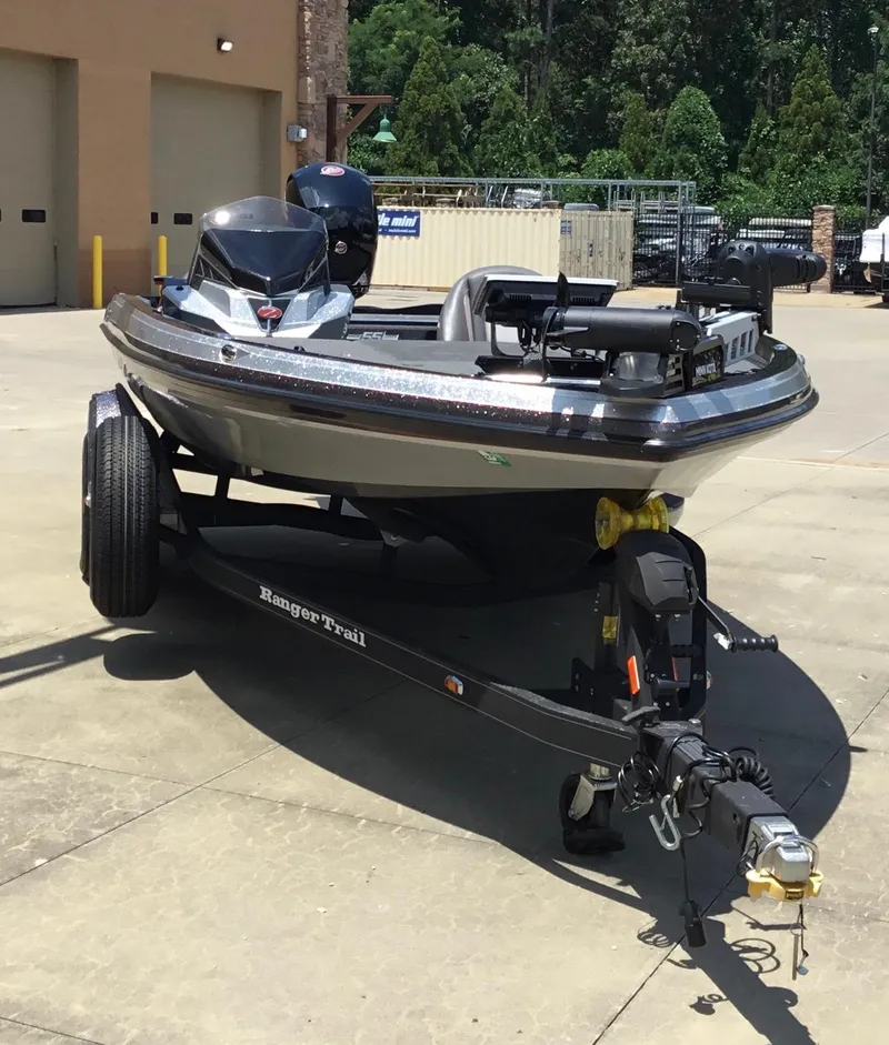 Slide: The Image of 2023 Ranger Z518 boat on trailer in outdoor setting. - 2