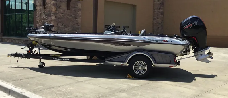 Slide: The Image of 2023 Ranger Z518 boat on trailer, parked outdoors, side view. - 6