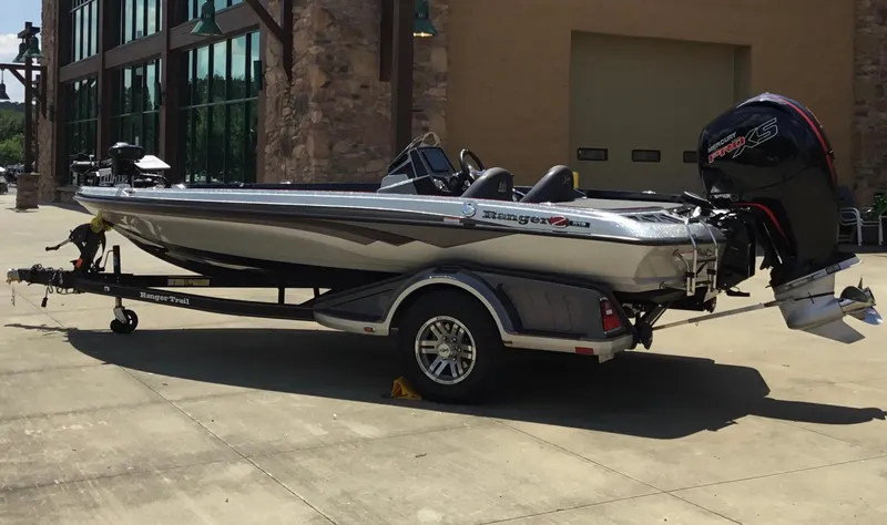 Slide: The Image of 2023 Ranger Z518 boat on trailer, parked outdoors near a building. - 7