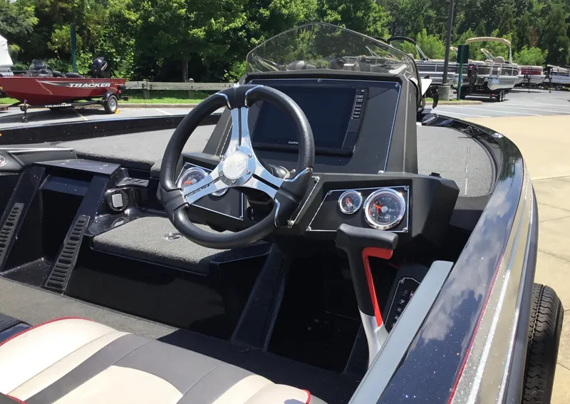 Slide: The Image of 2023 Ranger Z518 boat cockpit with steering wheel and dashboard controls. - 8