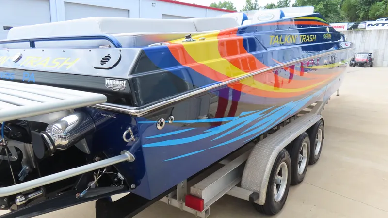 Slide: The Image of 2007 Active Thunder 37 powerboat with vibrant graphics on a trailer. - 10