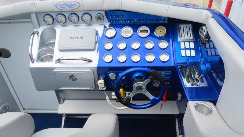 Slide: The Image of Dashboard of a 2007 Active Thunder 37 boat with gauges and controls. - 13