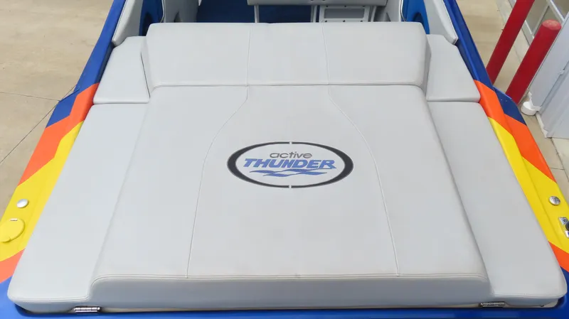 Slide: The Image of 2007 Active Thunder 37 boat with cushioned seating and vibrant side accents. - 17