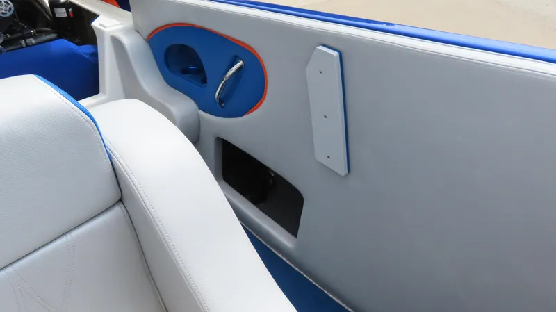 Slide: The Image of 2007 Active Thunder 37 boat interior with white and blue seating, gray paneling, and orange accents. - 18