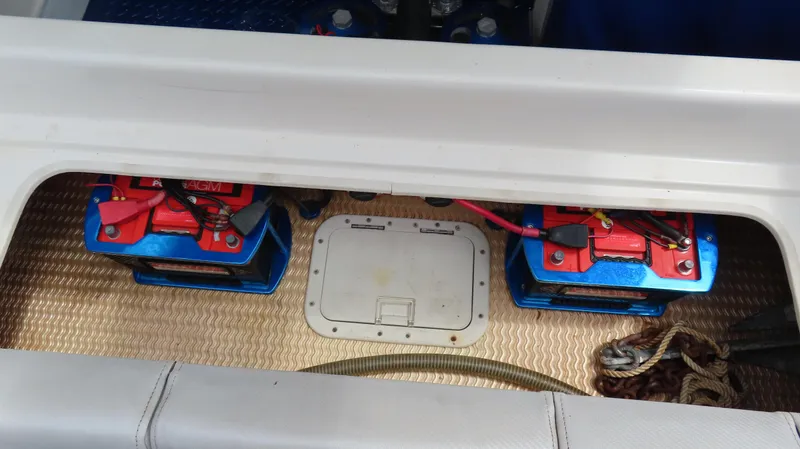 Slide: The Image of Battery compartment of a 2007 Active Thunder 37 boat, featuring dual AGM batteries. - 19