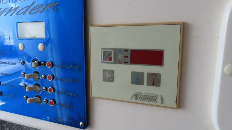 Slide: The Image of Control panel of a 2007 Active Thunder 37 boat, featuring climate and system controls. - 20