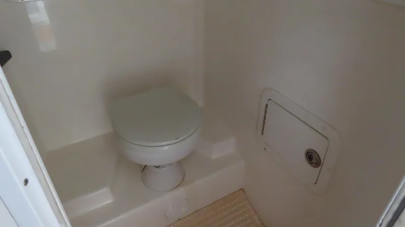 Slide: The Image of 2007 Active Thunder 37 boat interior bathroom with toilet and storage compartment. - 25