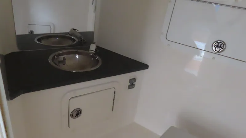 Slide: The Image of 2007 Active Thunder 37 boat interior with sink and storage compartments. - 26