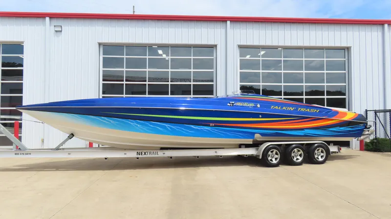 Slide: The Image of 2007 Active Thunder 37 speedboat with vibrant blue and orange design on a trailer. - 3