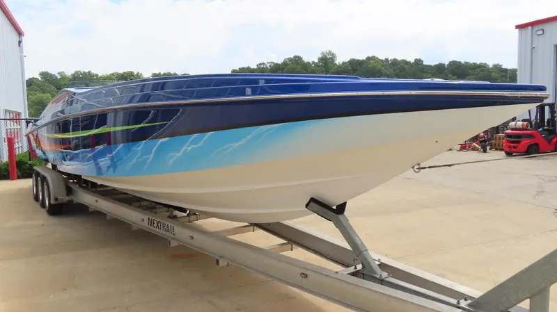 Slide: The Image of 2007 Active Thunder 37 powerboat on trailer, featuring vibrant blue and white design. - 6