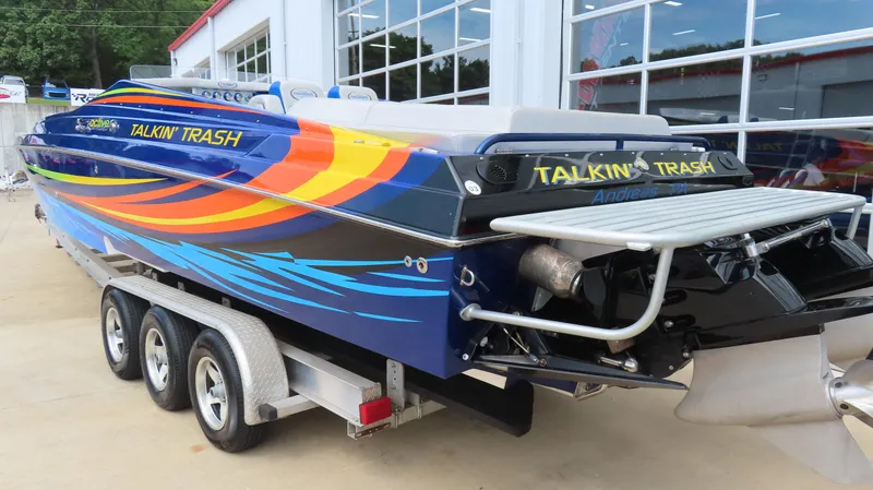 Slide: The Image of 2007 Active Thunder 37 powerboat with vibrant graphics on a trailer. - 7