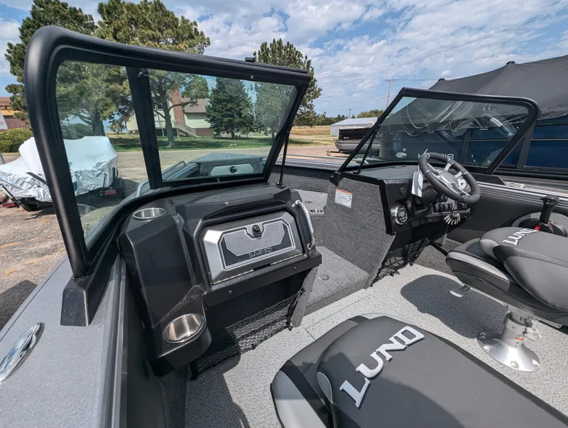 Slide: The Image of Interior of 2025 Lund 1975 Tyee boat with steering wheel and seating. - 14