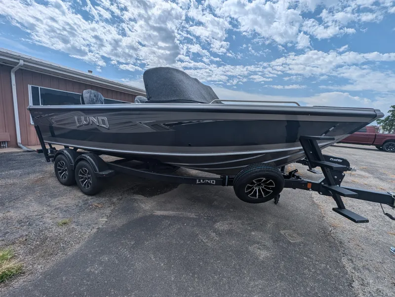 Slide: The Image of 2025 Lund 1975 Tyee boat on trailer under a cloudy sky. - 8