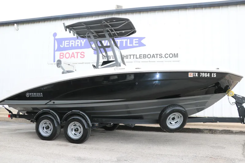 Slide: The Image of 2019 Yamaha Boats 210 FSH Sport on trailer at dealership. - 1