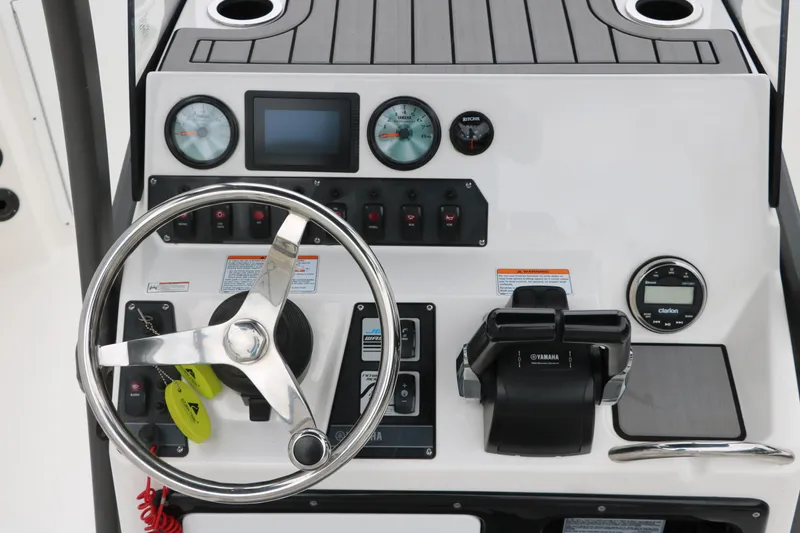 Slide: The Image of Control panel of 2019 Yamaha Boats 210 FSH Sport with steering wheel and gauges. - 12