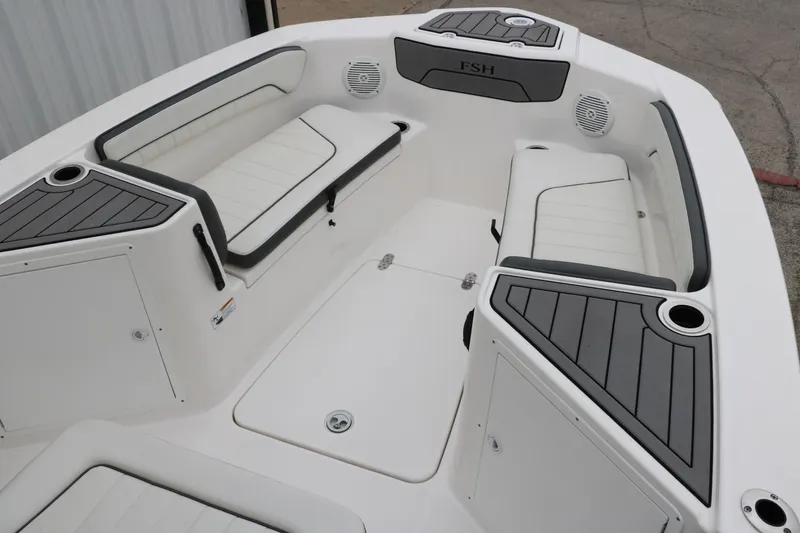 Slide: The Image of 2019 Yamaha Boats 210 FSH Sport interior with cushioned seating and storage compartments. - 13