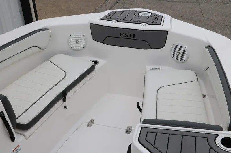 Slide: The Image of 2019 Yamaha Boats 210 FSH Sport interior with white seating and speakers. - 15