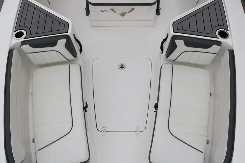 Slide: The Image of 2019 Yamaha Boats 210 FSH Sport interior seating, featuring sleek white and black design. - 16