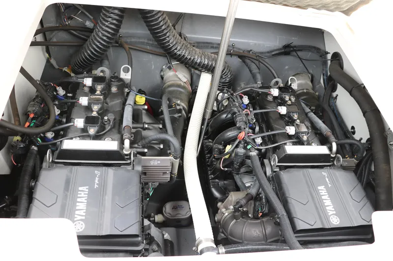 Slide: The Image of Engine compartment of a 2019 Yamaha Boats 210 FSH Sport, showcasing dual Yamaha engines. - 26