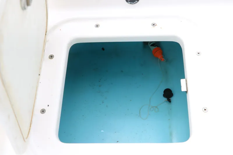 Slide: The Image of Open storage compartment in 2019 Yamaha Boats 210 FSH Sport, showing interior details. - 27