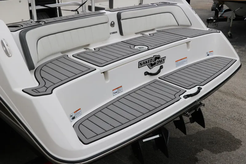 Slide: The Image of 2019 Yamaha Boats 210 FSH Sport swim platform with gray traction pads and seating. - 7