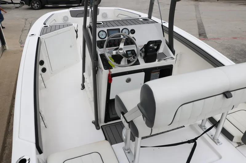 Slide: The Image of 2019 Yamaha Boats 210 FSH Sport interior with steering console and seating. - 9