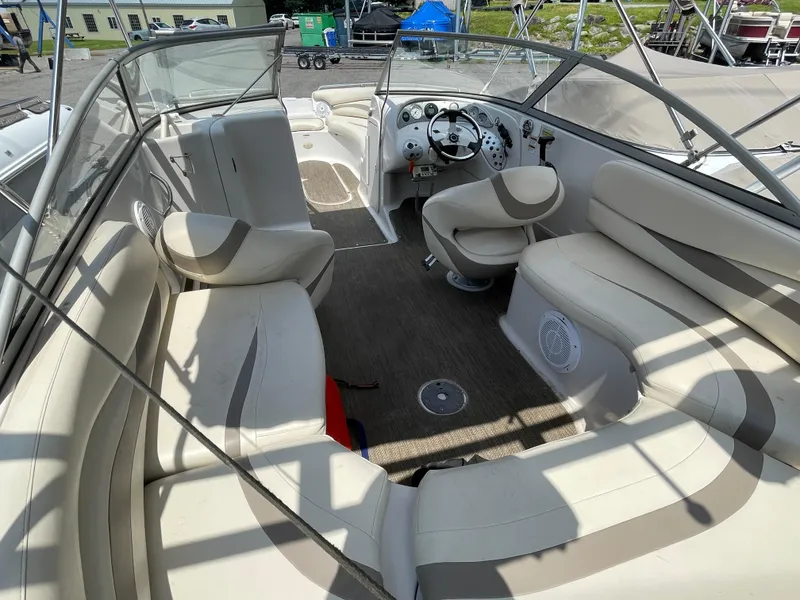 Slide: The Image of 2007 Starcraft 2410 OB Limited boat interior with beige seating and steering console. - 11
