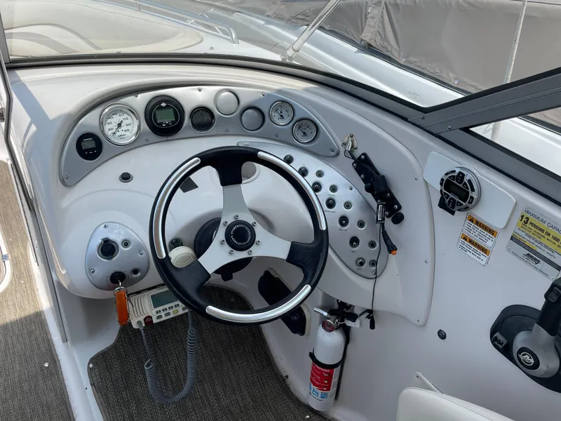 Slide: The Image of 2007 Starcraft 2410 OB Limited boat dashboard with steering wheel and gauges. - 12