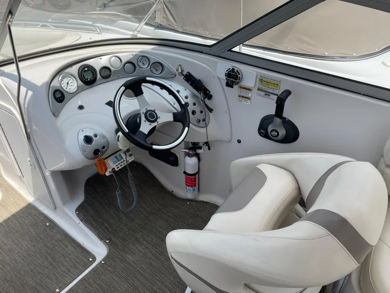 Slide: The Image of 2007 Starcraft 2410 OB Limited boat cockpit with steering wheel and gauges. - 16