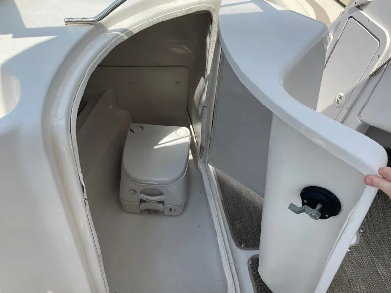 Slide: The Image of 2007 Starcraft 2410 OB Limited boat interior with portable toilet compartment. - 17
