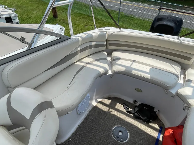 Slide: The Image of 2007 Starcraft 2410 OB Limited boat interior with white cushioned seating and carpeted floor. - 18