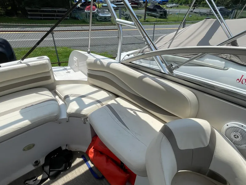 Slide: The Image of Interior of 2007 Starcraft 2410 OB Limited boat with white seating and metal railings. - 19