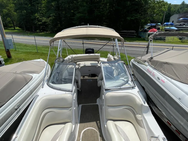 Slide: The Image of 2007 Starcraft 2410 OB Limited boat with beige canopy and white interior, docked outdoors. - 20