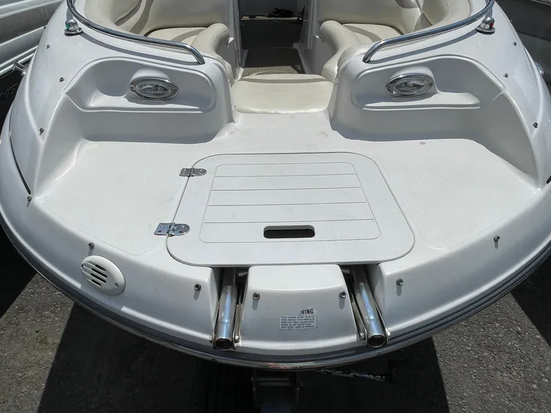 Slide: The Image of 2007 Starcraft 2410 OB Limited boat, white deck with seating and stainless steel features. - 8