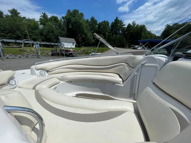 Slide: The Image of 2007 Starcraft 2410 OB Limited boat interior with white seating and outdoor setting. - 9