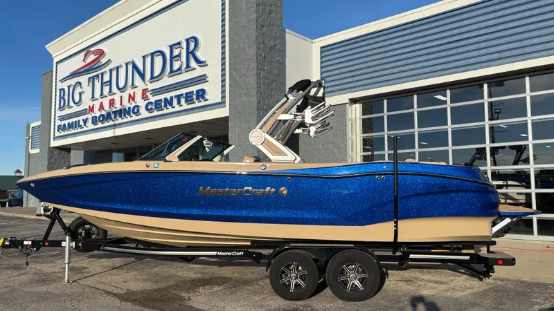 The Image of 2022 MasterCraft X26 boat in blue, displayed at Big Thunder Marine dealership. - 1