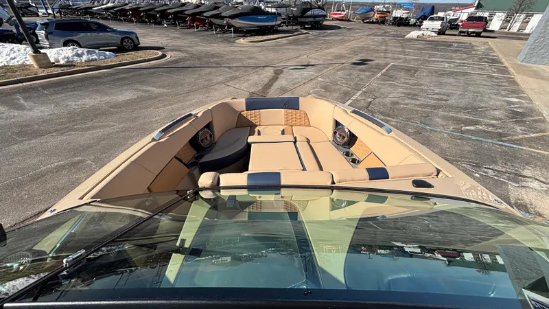 Slide: The Image of 2022 MasterCraft X26 boat with tan seating in a parking lot. - 11
