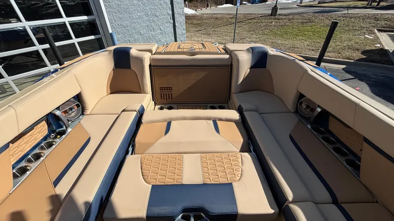 Slide: The Image of 2022 MasterCraft X26 boat interior with luxurious tan and blue seating. - 16
