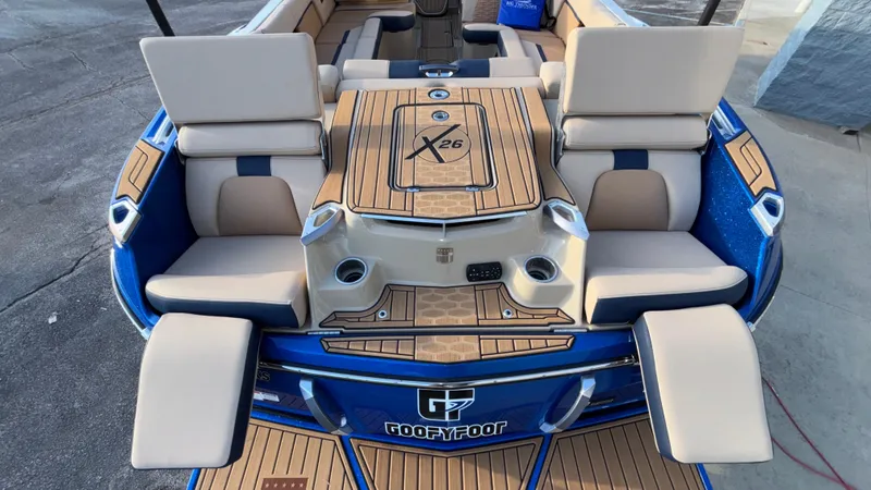 Slide: The Image of 2022 MasterCraft X26 boat interior with luxurious seating and teak-style flooring. - 23