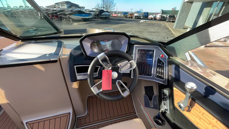 Slide: The Image of 2022 MasterCraft X26 boat dashboard with modern controls and steering wheel. - 26