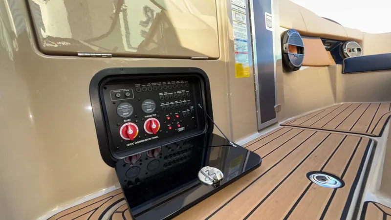 Slide: The Image of 2022 MasterCraft X26 boat interior with control panel and teak flooring. - 30