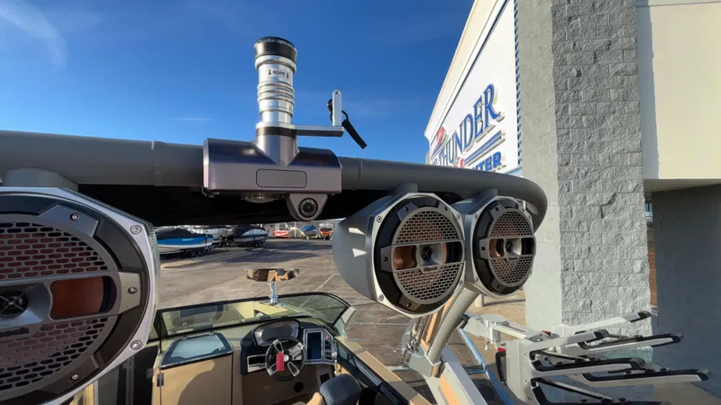 Slide: The Image of 2022 MasterCraft X26 boat with speakers and tower, parked at a dealership. - 34