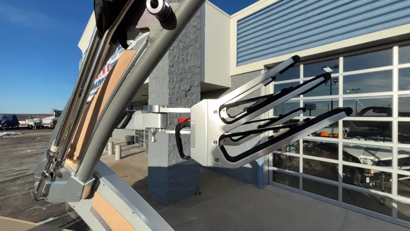 Slide: The Image of 2022 MasterCraft X26 boat with a wakeboard rack, displayed outside a showroom. - 35