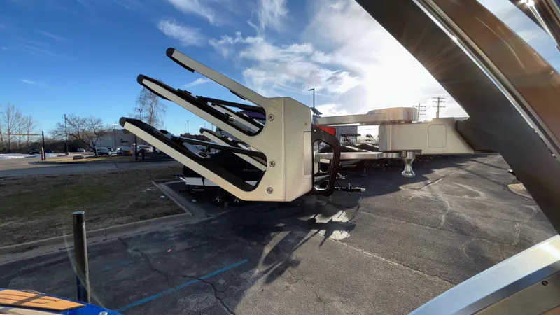 Slide: The Image of 2022 MasterCraft X26 boat with wakeboard rack under a clear sky. - 36