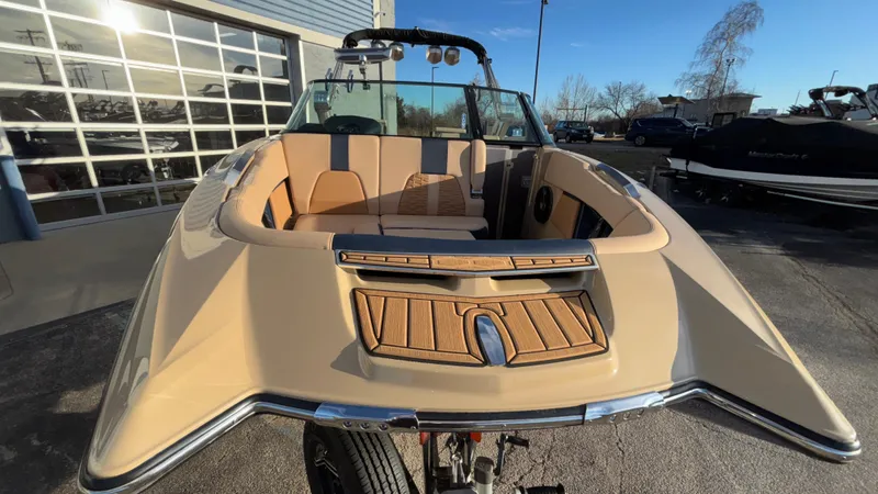 Slide: The Image of 2022 MasterCraft X26 boat with tan interior, parked outdoors. - 38