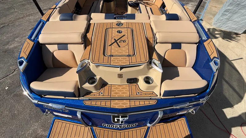 Slide: The Image of 2022 MasterCraft X26 boat with tan seating and blue accents. - 6