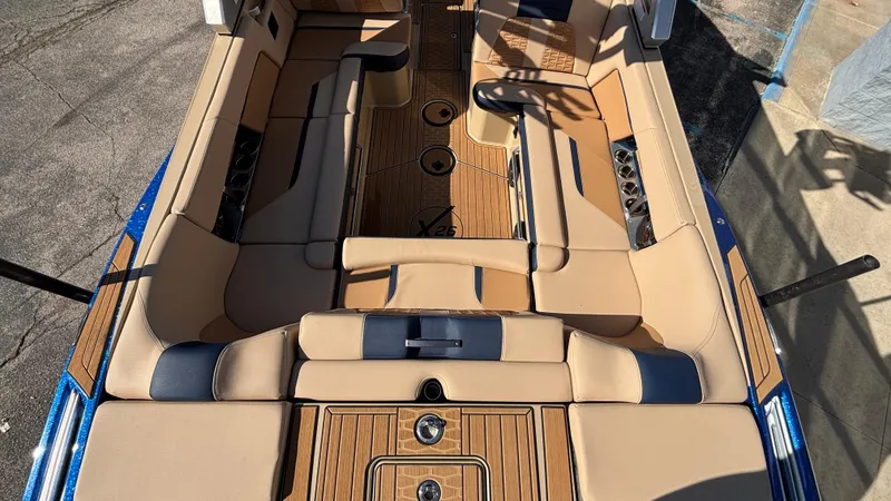 Slide: The Image of 2022 MasterCraft X26 boat interior with tan and blue seating, showcasing luxury design. - 8