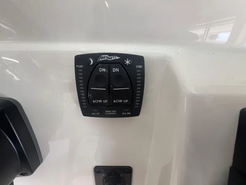 Slide: The Image of Bennett trim tab control on 2026 Pioneer 220 Bay Sport boat dashboard. - 10